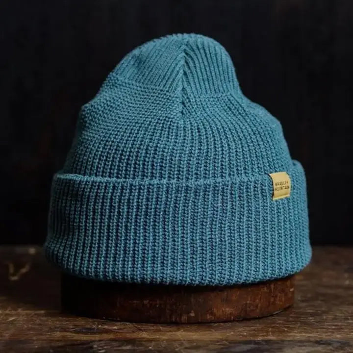 Vibrant azure knit beanie with a folded brim, combining cozy warmth with a bold, modern outdoor style