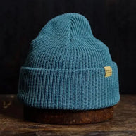 Vibrant azure knit beanie with a folded brim, combining cozy warmth with a bold, modern outdoor style