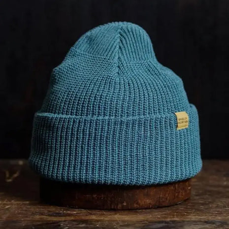 Vibrant azure knit beanie with a folded brim, combining cozy warmth with a bold, modern outdoor style