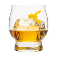 Whiskey glass with a large ice cube and citrus twist, highlighting its curved design for savoring refined drinks