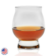 Whiskey glass with a rich amber pour, featuring a rounded shape and sturdy base for classic sipping style