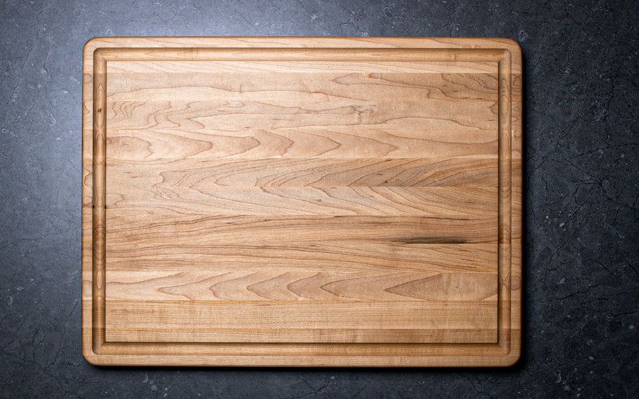 Wooden cutting board on a dark gray surface