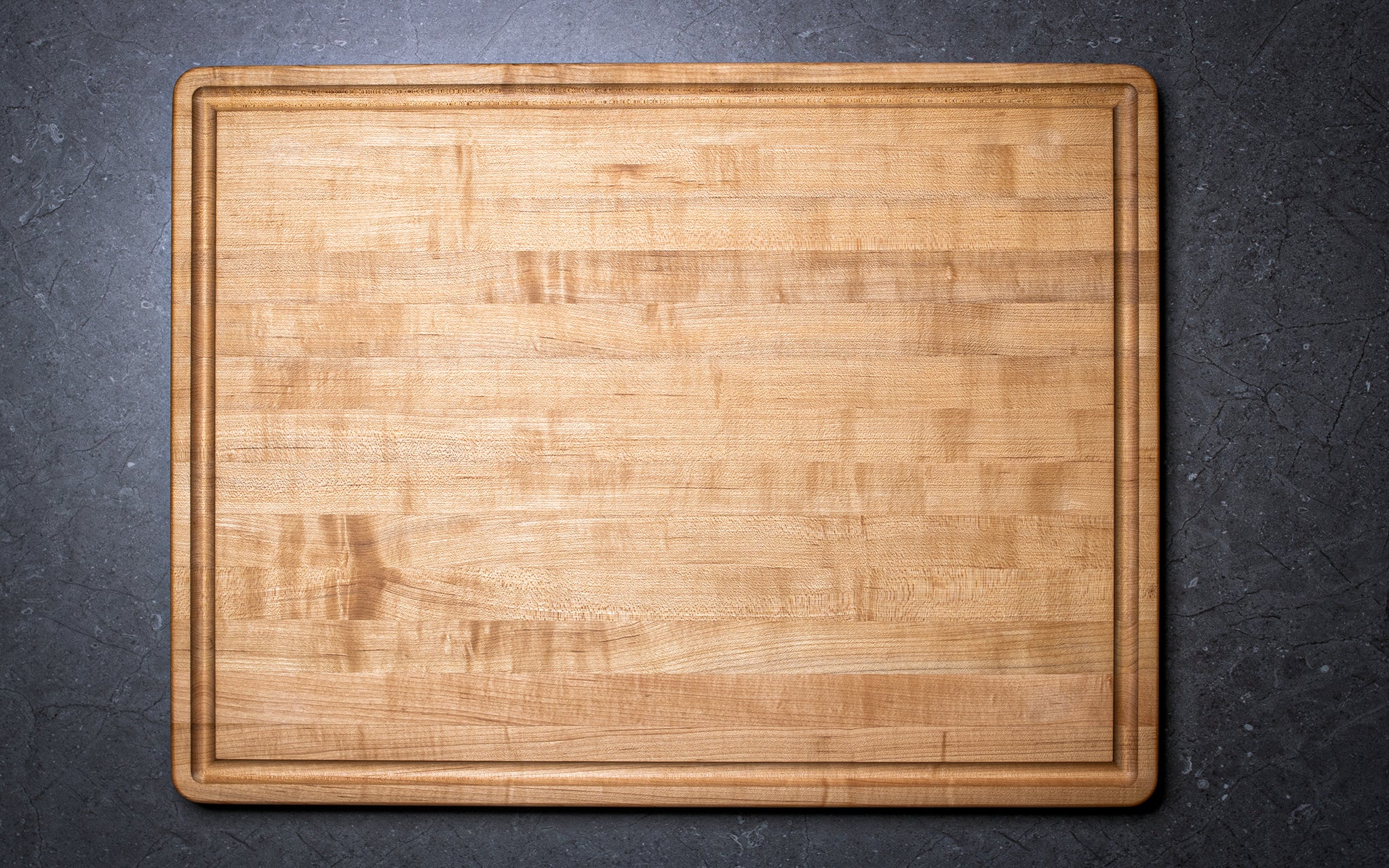Wooden cutting board on a dark gray background