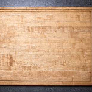 Wooden cutting board on a dark gray background