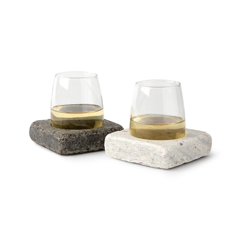 Set of glasses resting in square stone bases, designed to keep drinks chilled while adding a rustic, modern touch