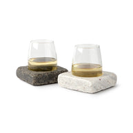Set of glasses resting in square stone bases, designed to keep drinks chilled while adding a rustic, modern touch