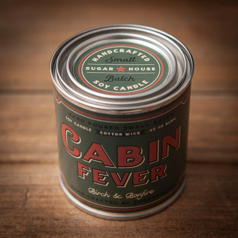 Front of Sugarhouse Cabin Fever soy candle in paint-can style tin. Label reads ‘Cabin Fever – Birch & Bonfire.’ Hand-poured small batch with cotton wick, 40-hour burn time. Handcrafted by Sugarhouse