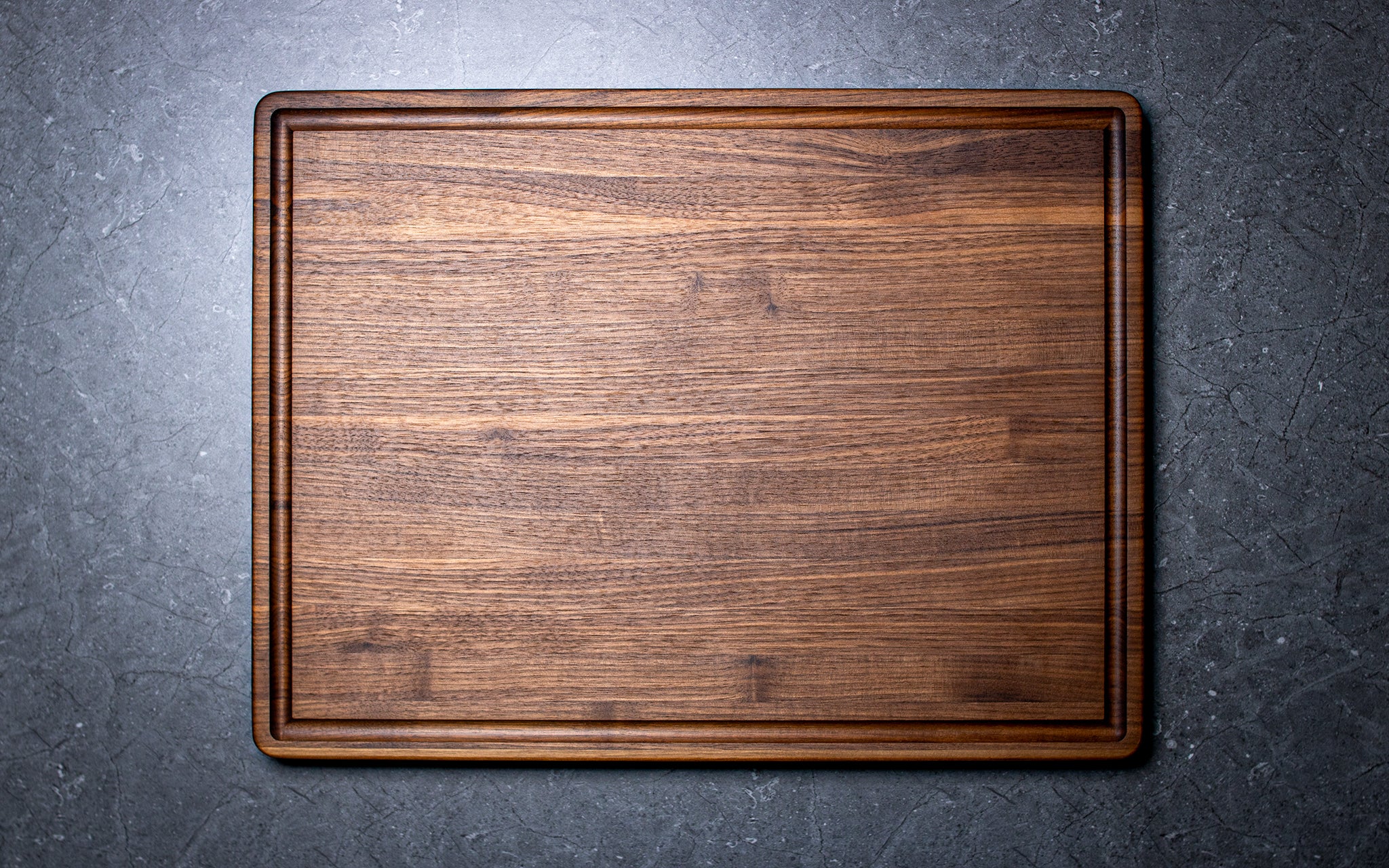 Wooden cutting board on a dark gray surface