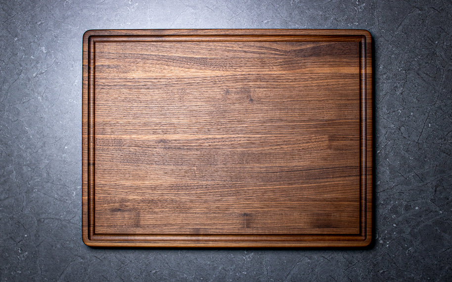 Wooden cutting board on a dark gray surface