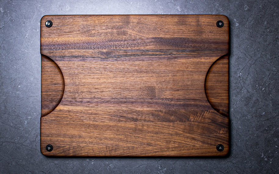Wooden cutting board with rubber feet and handles