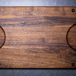 Wooden cutting board with rubber feet and handles