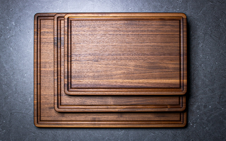 Stack of wooden cutting boards on a gray surface